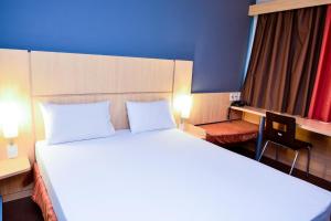 Cama ou camas em um quarto em Amapá Hotel