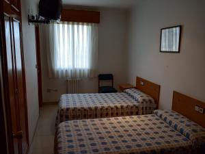 Postel nebo postele na pokoji v ubytování Hostal Mobydick2