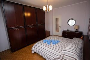 a bedroom with a bed with two blue shoes on it at Spezia in Turin