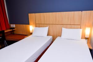 Cama ou camas em um quarto em Amapá Hotel