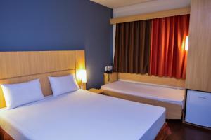 Cama ou camas em um quarto em Amapá Hotel