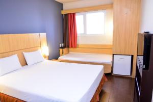 Cama ou camas em um quarto em Amapá Hotel