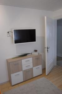 a living room with a flat screen tv on a wall at Panorama-Rheinblick St. Goar in Sankt Goar