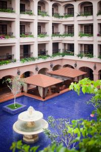 a large building with a fountain in front of it at Casa del Rio Melaka in Malacca