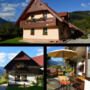 une maison avec une terrasse et un parasol dans l'établissement Apartmaji BOHINJ, à Bohinj