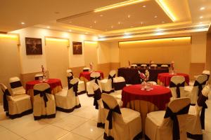 a banquet hall with tables and chairs in a room at Hotel KC Palace in Bhopal