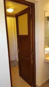 an open door to a bathroom with a mirror at Casacerro in Salta +9 photos