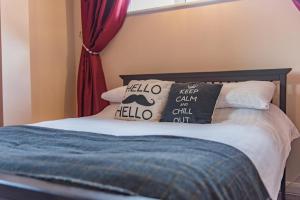 a bed with two pillows on top of it at Garden Oasis in Margate