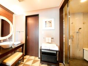a bathroom with a sink and a shower at The Royal Park Hotel Iconic Tokyo Shiodome in Tokyo