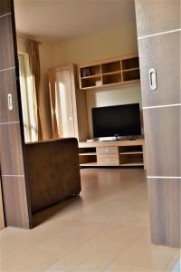 a large living room with a flat screen tv at Apartament Gabrysia 7 in Międzywodzie