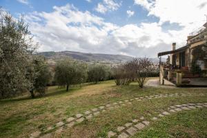 a house with a stone path leading to a yard at Independent loft on Florence's hills in Fiesole