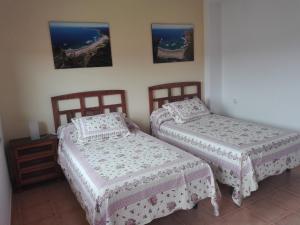 sypialnia z 2 łóżkami i stołem w obiekcie Apartamento A Nave w mieście Fisterra