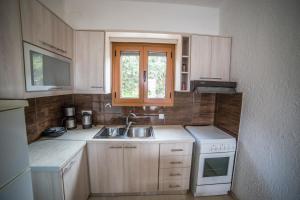 a small kitchen with a sink and a stove at Bay View Apartments in Sitia