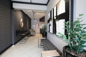 a lobby with a waiting area with chairs and plants at Florida Park Hotel, Florida Road in Durban