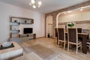 a kitchen and dining room with a table and chairs at Hana Accommodation in Sveti Stefan