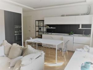 a living room with a white couch and a table at EXCELSIOR 10 - Luxury apartment in Grado