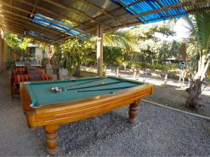 a pool table sitting under awning in a patio at Bosque Marino Ecolodge in Puerto López