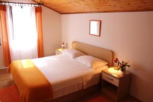 a bedroom with a large bed and a window at Apartments Boris in Zaton