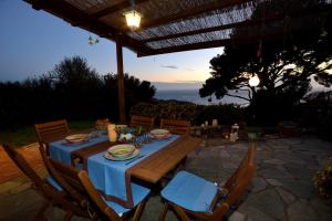 a table with a blue table cloth on a patio at Casa Margherita in Imperia