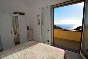 a bedroom with a bed and a view of the ocean at Casa Margherita in Imperia