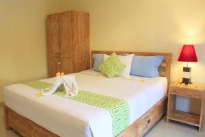 Postel nebo postele na pokoji v ubytování CR Tris Rooms Seminyak