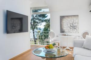 a living room with a table with a bowl of fruit on it at Apartment Hannah in Novigrad Istria