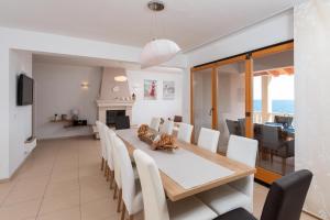 a dining room and living room with a table and chairs at Exceptional Beachfront Holiday Villa on Korčula Island in Prizba