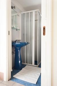 a bathroom with a blue sink and a shower at Le Due Sorelle in Specchia