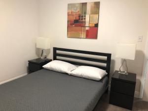 a bedroom with a bed with two night stands and two lamps at Close to Everything Miami in Miami