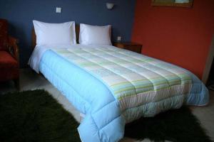 a bedroom with a large bed with white pillows at Guesthouse Mitsiopoulou in Neochori