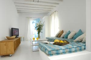 a living room with a couch and a table at Kapetan Tasos Suites in Pollonia