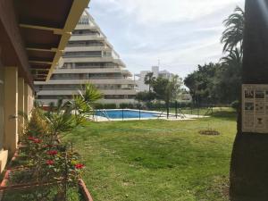 widok na budynek apartamentowy i basen w obiekcie Apartamento DELUXE Benalmádena w mieście Benalmádena