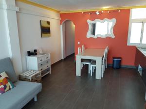 a dining room with a table and a chair at Apartment Calle Larga in Fuengirola