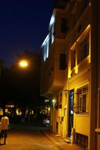 a person walking down a street at night with a street light at Uyar Apt in Istanbul