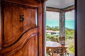 a wooden door with a table on a balcony at El Mirador Ecológico, Ometepe in Altagracia