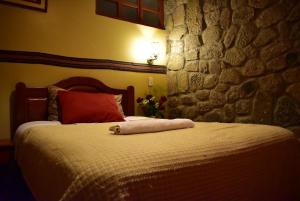 Giường trong phòng chung tại Kuska Hostal