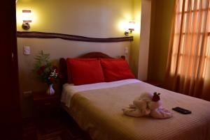 Giường trong phòng chung tại Kuska Hostal