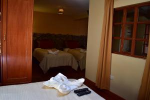 Giường trong phòng chung tại Kuska Hostal