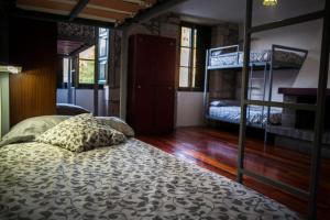 a bedroom with a bed and bunk beds in it at Albergue Convento Del Camino in Tui