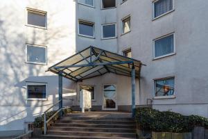 a building with stairs in front of a building at 2 Wildpferdehut in Essen