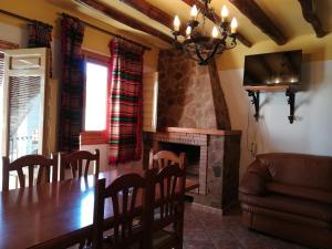 a dining room with a table and a fireplace at Alojamientos Rurales Las Eras in Granada