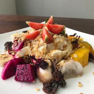 a plate of food with fruit on top of it at Casa Narrow Villa in Nembrala