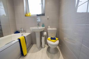 a bathroom with a white toilet and a sink at PREMIER - Garfield Apartment in Bellshill