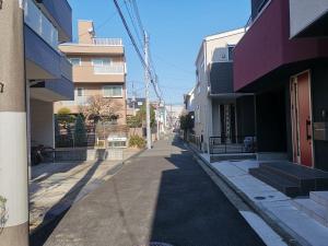 an empty street in a city with buildings at Red & Black House Yokohama Tennocho in Yokohama