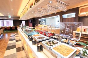 a buffet line with dishes of food in a restaurant at Urban Hotel Kyoto in Kyoto