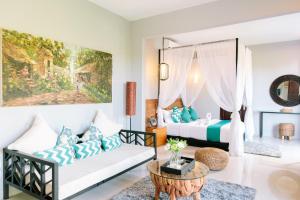 a living room with two beds and a couch at Villa Habibi in Uluwatu +41 photos