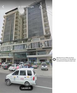 a white car parked in front of a building at M's Places ORES in Bacolod