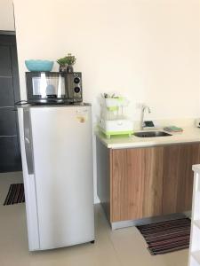 a kitchen with a microwave on top of a refrigerator at M's Places ORES in Bacolod