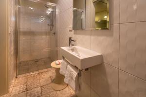 a bathroom with a sink and a toilet and a shower at Cygnet, Studio on Sturt in Wendouree