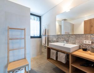 a bathroom with a sink and a mirror at naturApart in Brunico +38 photos